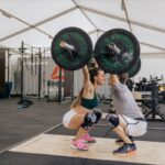 why do dumbbells feel heavier than barbells